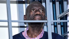 Opposition leader Kizza Besigye stands in a steel dock at the Uganda Military General Court Martial in Makindye, a suburb of Kampala, Uganda 2 December 2024. Source: Reuters, Abubaker Lubowa.