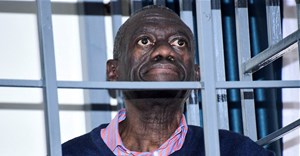 Opposition leader Kizza Besigye stands in a steel dock at the Uganda Military General Court Martial in Makindye, a suburb of Kampala, Uganda 2 December 2024. Source: Reuters, Abubaker Lubowa.