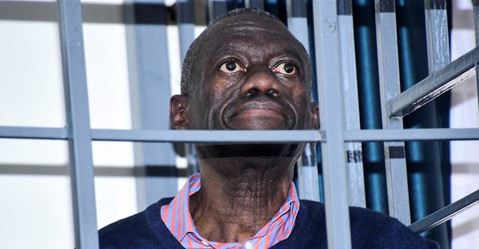 Opposition leader Kizza Besigye stands in a steel dock at the Uganda Military General Court Martial in Makindye, a suburb of Kampala, Uganda 2 December 2024. Source: Reuters, Abubaker Lubowa.