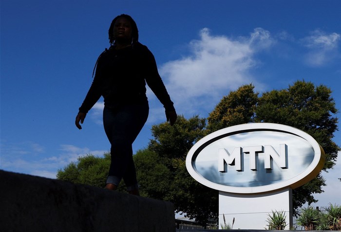 File photo: A person walks past a MTN logo outside the company's headquarters in Johannesburg, South Africa, on 17 November 2023. Reuters/Siphiwe Sibeko/File photo
