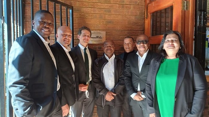 Air Products representatives Maropeng Bahula, Byron Ah Tow, Charles Dos Santos, Gift Nyambe, Mr Rickets (Odin Park Primary), Sizwe Nkonde, and Arthi Govender proudly display the plaque