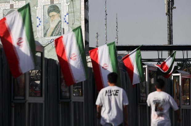 Source: Reuters. People walk near a mural of Iran's Supreme Leader, Ayatollah Ali Khamenei, amid the Iran-Israel conflict, in Tehran, Iran, 23 June, 2025. Majid Asgaripour/WANA (West Asia News Agency).
