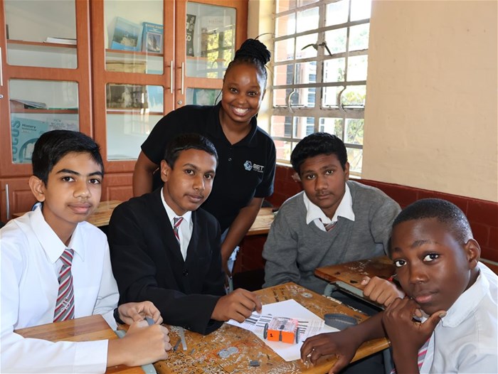 Zama Mdlalose, senior marketing co-ordinator at BET Software, supports learners during a Coding & Robotics lesson.