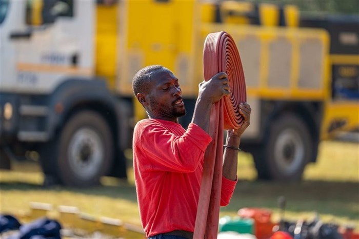 Fire suppression demonstration underway at Ndubazi District, showcasing techniques.