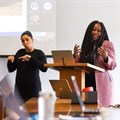 Supplied photo: Sign language interpreter Michelle de Bruyn doing the interpreting as Professor Salome Maswime speaks during a recent event.