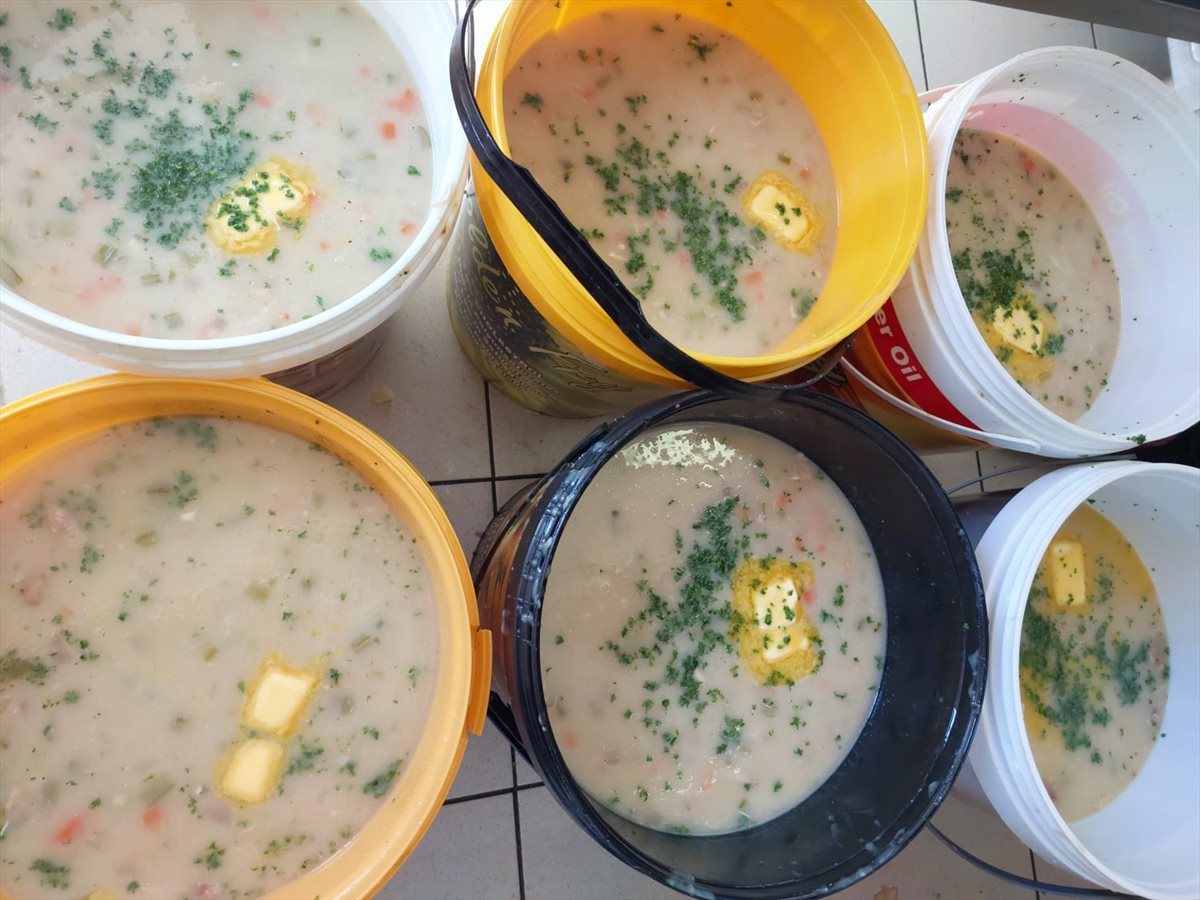 Buckets of chicken soup made by Capsicum Culinary Studio and SYSPRO volunteers. Image supplied.