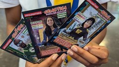A learner holds up trading cards featuring some of the SuperScientists. This cartoon series, created by Justin Yarrow with a team of local scientists, illustrators and designers, is based on real-life African scientists. Photos: Justin Yarrow/SuperScientists