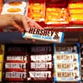 An employee shows a Hershey's chocolate bar made in USA in the &quot;American lifestyle&quot; store in Berlin, Germany, 13 August 2018. Reuters/Fabrizio Bensch/File Photo