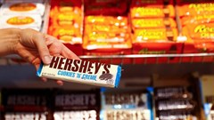 An employee shows a Hershey's chocolate bar made in USA in the "American lifestyle" store in Berlin, Germany, 13 August 2018. Reuters/Fabrizio Bensch/File Photo