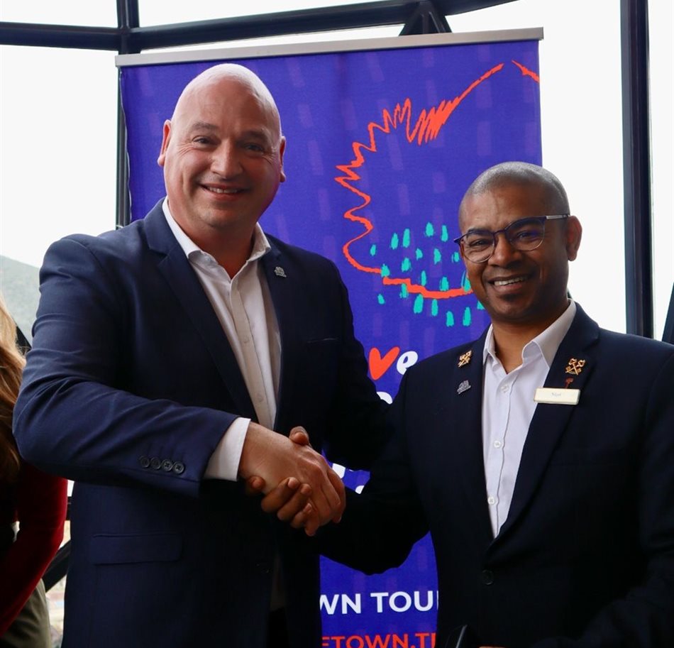 Alderman James Vos pins a #LoveCapeTown badge onto Nigel Oosthuizen, Head Concierge at the 12 Apostles Hotel & Spa.