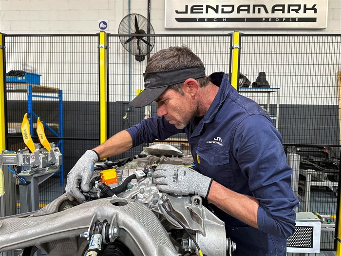 Jendamark automation engineer works on an automotive component for a vehicle to be exported, at Nelson Mandela University in Gqeberha, as the annual South African vehicle component manufacturers conference takes place, with a particular focus on how the industry is adapting to U.S. tariffs, in Gqeberha, Eastern Cape province, South Africa, 13 August 2025. Reuters/Shafiek Tassiem