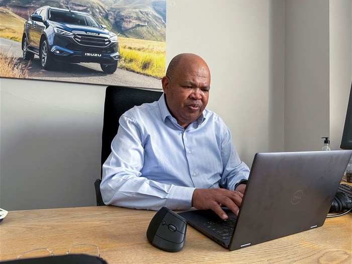 Isuzu Motors South Africa president and CEO Billy Tom works on his laptop at Isuzu's distribution facility in Gqeberha, South Africa, 15 August 2025. Reuters/Nqobile Dludla