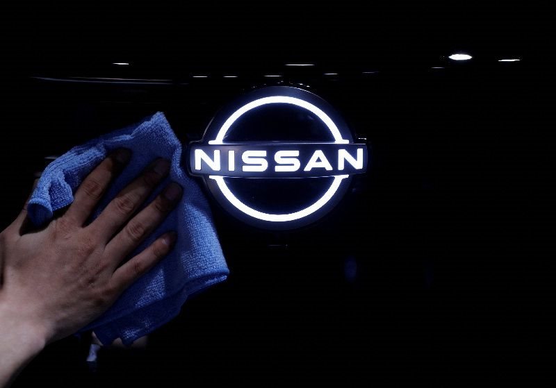 File photo: A man wipes the logo of Nissan Motor on the Ariya all-battery SUV during a press preview at the Nissan Pavilion in Yokohama, south of Tokyo, Japan, on 14 July 2020. Reuters/Issei Kato/File Photo