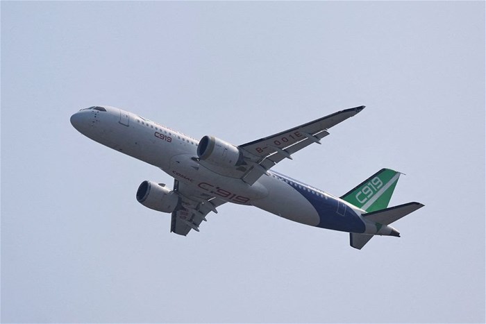 A Comac C919 narrowbody airliner flies in the sky at the China International Aviation and Aerospace Exhibition, or Airshow China, in Zhuhai, Guangdong province, China, 12 November 2024. Reuters/Tingshu Wang/File Photo