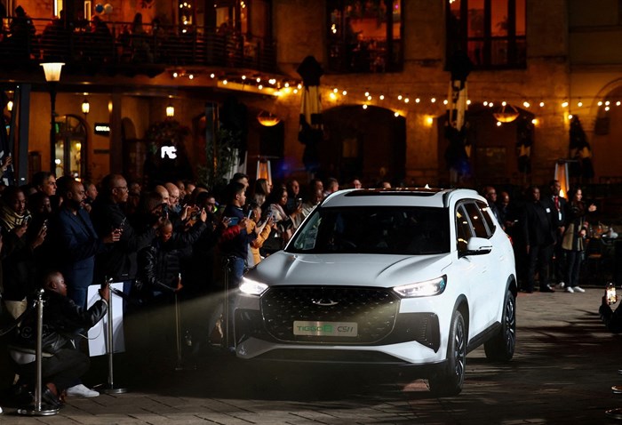 File photo: Onlookers take photographs of a Tiggo 8 model during the launch of Chery's new Super Hybrid (CSH) range of cars at Montecasino, in Johannesburg, South Africa, 20 June 2025. Reuters/Siphiwe Sibeko/File Photo