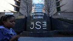 A woman walks at the Johannesburg Stock Exchange (JSE), in Sandton, South Africa, 1 August 2025. Reuters/Siphiwe Sibeko