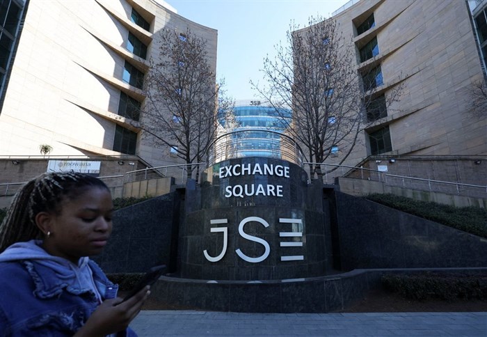 A woman walks at the Johannesburg Stock Exchange (JSE), in Sandton, South Africa, 1 August 2025. Reuters/Siphiwe Sibeko