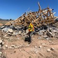 Phathutshedzo Mukwevho stands next to the demolished structure of Humbulani Nenzhelele. Photo: Maanda Bele / GroundUp