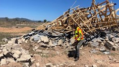 Phathutshedzo Mukwevho stands next to the demolished structure of Humbulani Nenzhelele. Photo: Maanda Bele / GroundUp