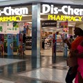 People walk past a Dis-Chem Pharmacy outlet in Cape Town, South Africa, 22 February 2024. Image credit: Reuters/Esa Alexander