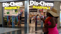 People walk past a Dis-Chem Pharmacy outlet in Cape Town, South Africa, 22 February 2024. Image credit: Reuters/Esa Alexander