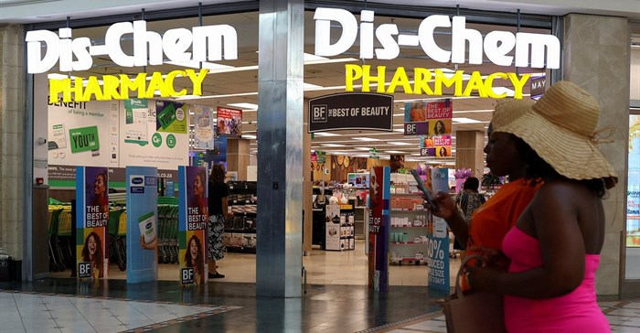 People walk past a Dis-Chem Pharmacy outlet in Cape Town, South Africa, 22 February 2024. Image credit: Reuters/Esa Alexander