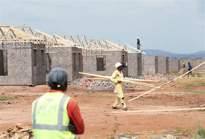 Workers are seen at a construction site at Protea Glen, a township of Johannesburg, South Africa, 19 March 2021. Reuters/Siphiwe Sibeko
