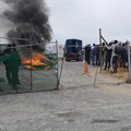 Workers protested outside this project site in Illitha Park, Khayelitsha, since Monday over their unpaid wages. Photo: Vincent Lali / GroundUp