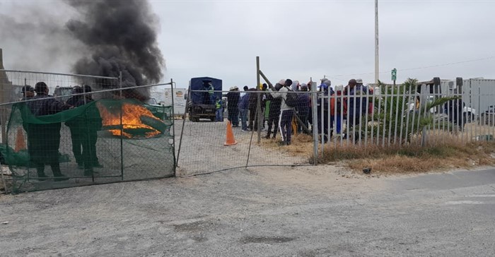 Workers protested outside this project site in Illitha Park, Khayelitsha, since Monday over their unpaid wages. Photo: Vincent Lali / GroundUp