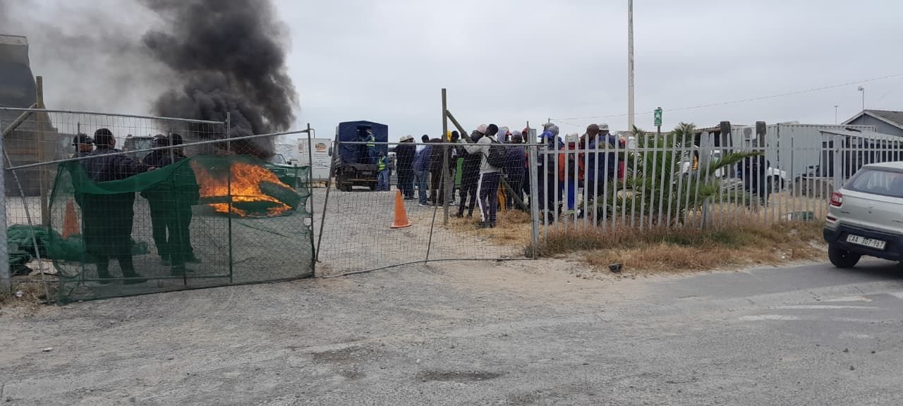 Workers protested outside this project site in Illitha Park, Khayelitsha, since Monday over their unpaid wages. Photo: Vincent Lali / GroundUp