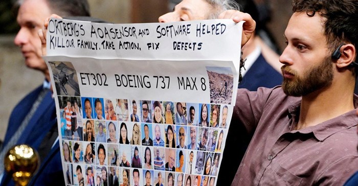 People hold a banner with pictures of victims of crashed Ethiopian Airlines flight 302 Boeing 737 Max 8 during Senate Commerce, Science, and Transportation Committee hearing about Boeing’s commitment to address safety concerns in the wake of a January 2024 mid-air emergency involving a new 737 Max, on Capitol Hill in Washington, DC, US, 2 April 2025. Reuters/Ken Cedeno/File Photo