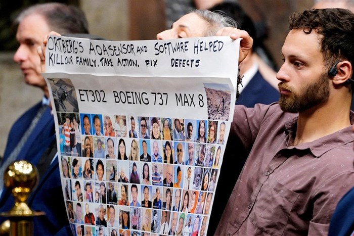 People hold a banner with pictures of victims of crashed Ethiopian Airlines flight 302 Boeing 737 Max 8 during Senate Commerce, Science, and Transportation Committee hearing about Boeing’s commitment to address safety concerns in the wake of a January 2024 mid-air emergency involving a new 737 Max, on Capitol Hill in Washington, DC, US, 2 April 2025. Reuters/Ken Cedeno/File Photo