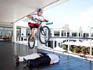 Kenny Belaey, the Belgian mountain bike trial cyclist, doing an air jump over two individuals attending the event.